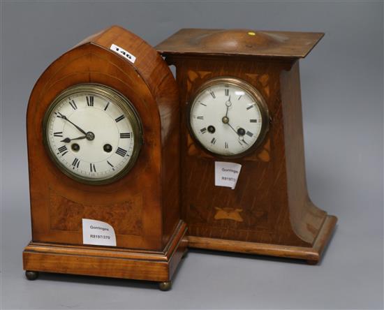 A late Victorian satinwood and burr walnut lancet-shaped mantel clock, and an Edwardian Art Nouveau oak and marquetry inlaid eight day